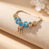 Aestify™ Aqua Dream Charm Bracelet – 18K Gold Tone | Premium CZ + Crystal Charms
